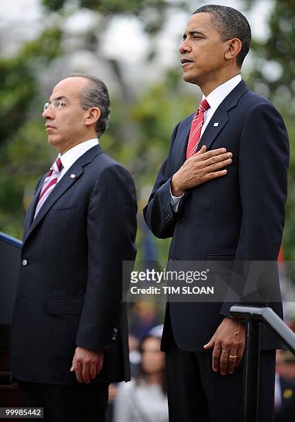 President Barack Obama stands with Mexican Presidernt Felipe Calderón during the State Arrival ceremony on the South Lawn of the White House on May...