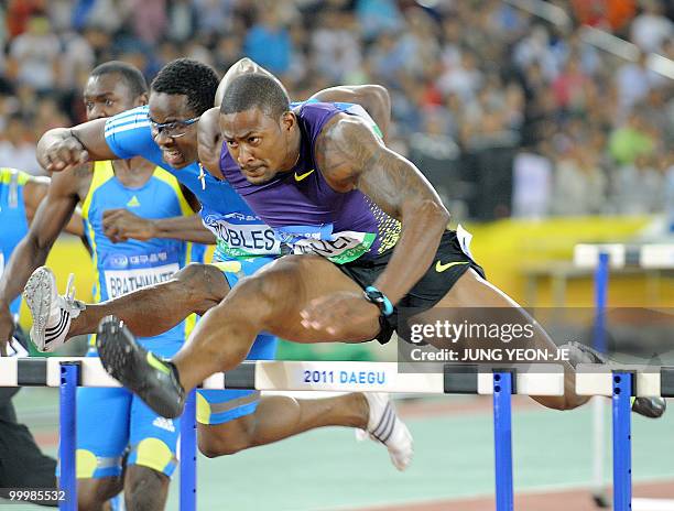 David Oliver of the US reces to the finish line ahead of Cuba's Dayron Robles in the men's 110 meter hurdle event of the Daegu Pre-Championships...