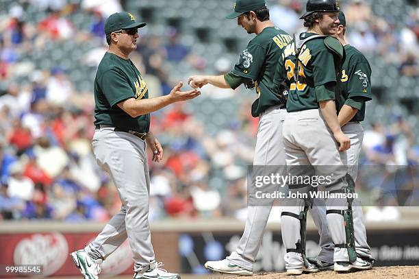 Manager Bob Geren of the Oakland Athletics visits the pitcher's mound to make a pitching change and asks for the ball from pitcher Jerry Blevins as...