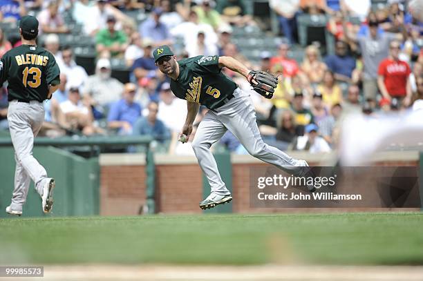 Third baseman Kevin Kouzmanoff of the Oakland Athletics fields his position as he fields a slow roller ground ball and looks to first base to see...