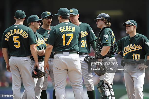 Manager Bob Geren of the Oakland Athletics visits the pitcher's mound to discuss the current situation in the game with the pitcher and the entire...