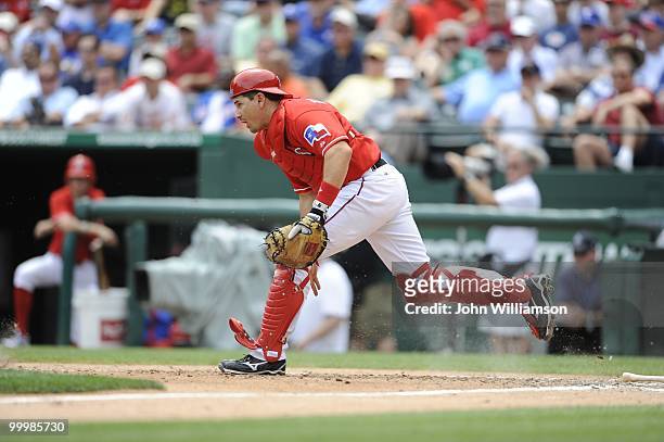 Catcher Matt Treanor of the Texas Rangers runs from his position behind home plate to pick up a bunted ball during the game against the Oakland...