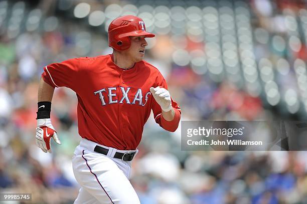 Justin Smoak of the Texas Rangers runs to first base after hitting the ball during the game against the Oakland Athletics at Rangers Ballpark in...