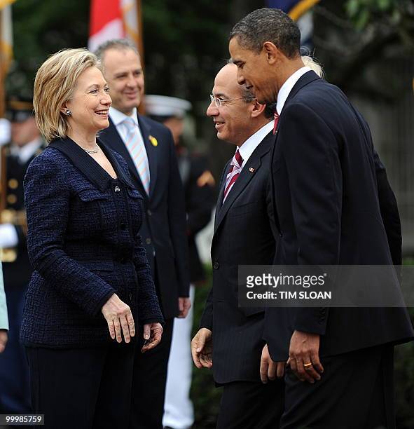President Barack Obama escorts Mexican President Felipe Calderón to greet Secretary of State Hillary Clinton during the State Arrival ceremony on the...