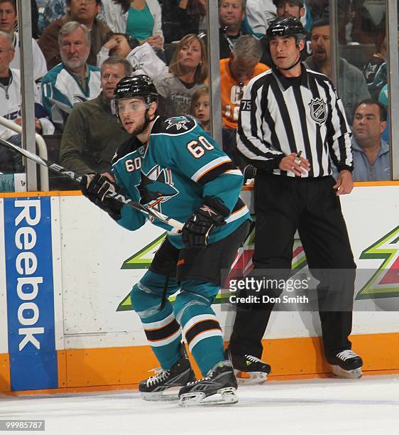 Jason Demers of the San Jose Sharks watches the play with linesman Derek Amell in Game One of the Western Conference Finals during the 2010 NHL...