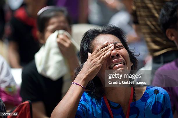 Thai anti-government red shirt protesters weep as their leaders tell them that their protest must end as Thai military forces advance on their...