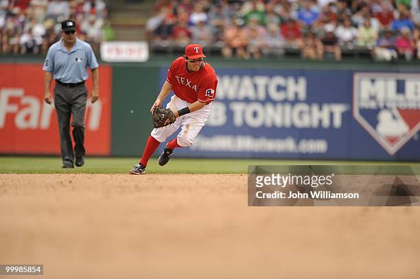Second baseman Ian Kinsler of the Texas Rangers fields his position as he catches a ground ball during the game against the Oakland Athletics at...
