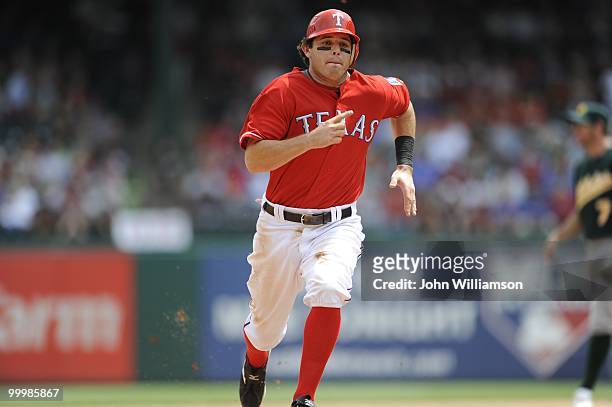 Ian Kinsler of the Texas Rangers runs the bases as he advances to third base during the game against the Oakland Athletics at Rangers Ballpark in...