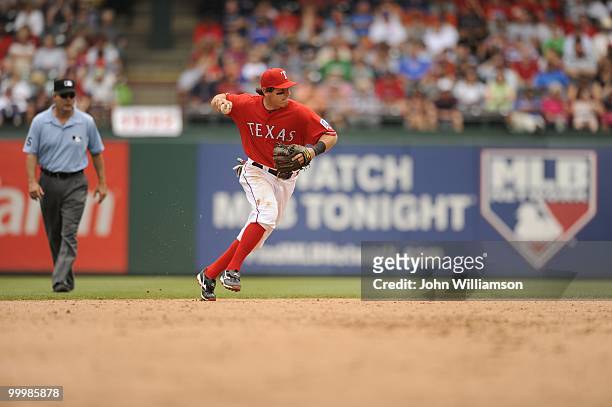 Second baseman Ian Kinsler of the Texas Rangers fields his position as he throws to first base after catching a ground ball during the game against...