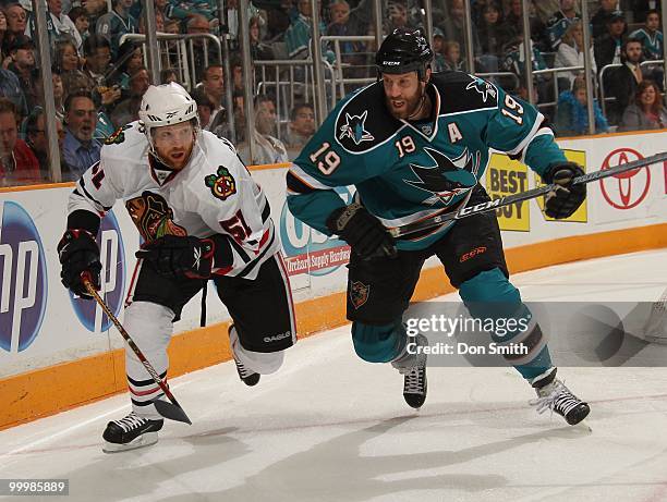 Brian Campbell of the Chicago Blackhawks battles for the puck with Joe Thornton of the San Jose Sharks in Game One of the Western Conference Finals...