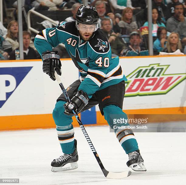 Kent Huskins of the San Jose Sharks moves the puck in Game One of the Western Conference Finals during the 2010 NHL Stanley Cup Playoffs against the...