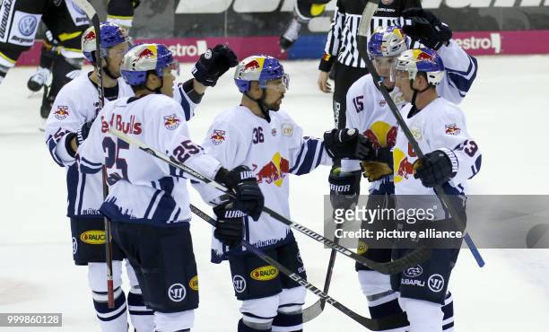Munich's Michael Wolf is celebrated for his 2:3 goal via penalty during the icehockey first league game between Krefeld Penguins and EHC Red Bull...