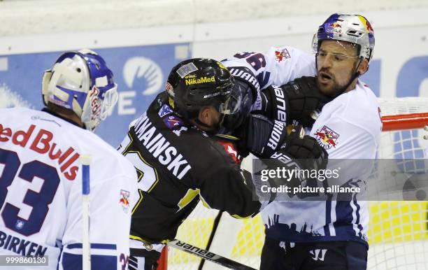 Munich's Yannic Seidenberg and Krefeld's Schymainski fight during the icehockey first league game between Krefeld Penguins and EHC Red Bull Munich in...