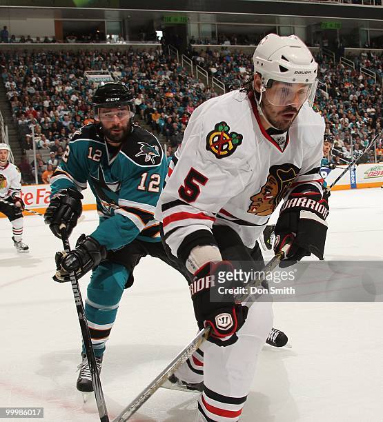 Brent Sopel of the Chicago Blackhawks battles with Patrick Marleau of the San Jose Sharks in Game One of the Western Conference Finals during the...