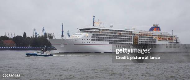 The 'Europa 2' cruise ship is escorted by a police boat during the cruise festival 'Hamburg Cruise Days' on Elbe river in Hamburg, Germany, 8...
