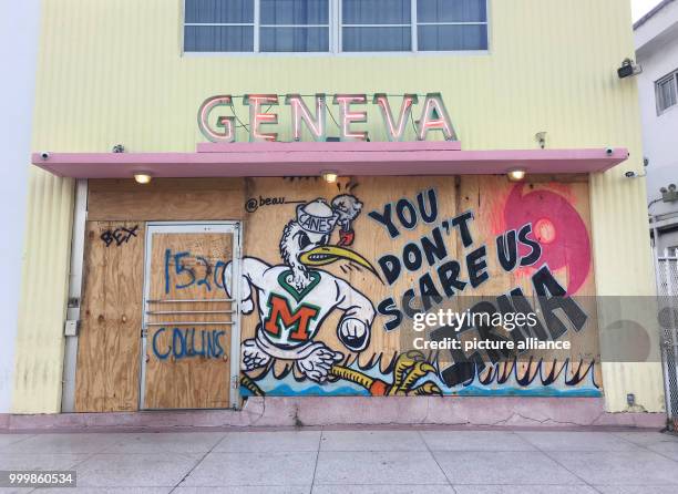 Graffiti reading 'You don't scare us Irma' can be seen on a hotel entrance covered in wood in Miami, US, 8 September 2017. After creating a path of...