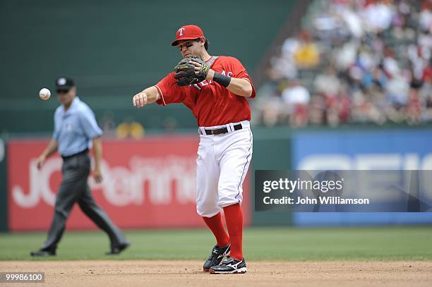 Second baseman Ian Kinsler of the Texas Rangers fields his position as he throws to first base after catching a ground ball during the game against...