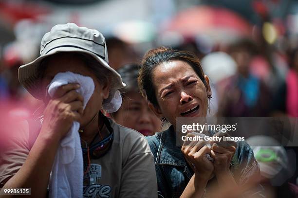 Thai anti-government red shirt protesters weep as their leaders tell them that their protest must end as Thai military forces advance on their...