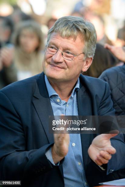 Joerg Meuthen, federal chairman of the AfD party, applaudes during the political 'pre-lunch drink' at the folk festival Gillamoos in Abensberg,...