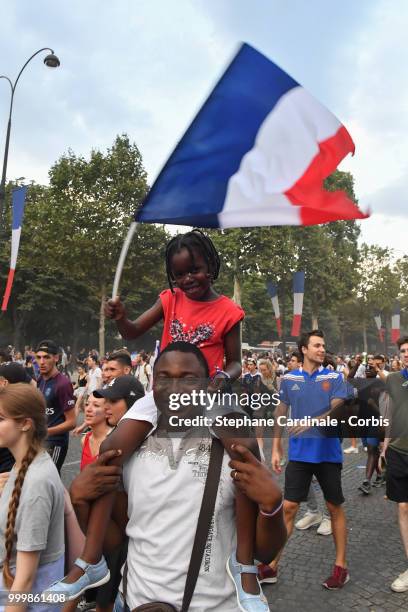Fans celebrate the Victory of France in the World Cup 2018, on the Champs Elysees on July 15, 2018 in Paris, France.