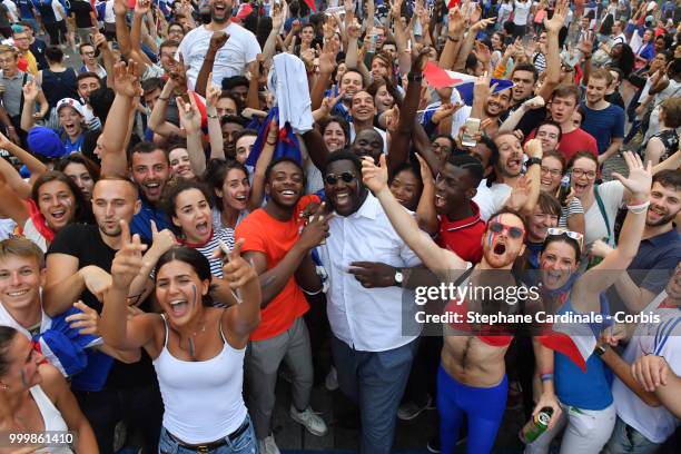 Fans celebrate the Victory of France in the World Cup 2018, on the Champs Elysees on July 15, 2018 in Paris, France.
