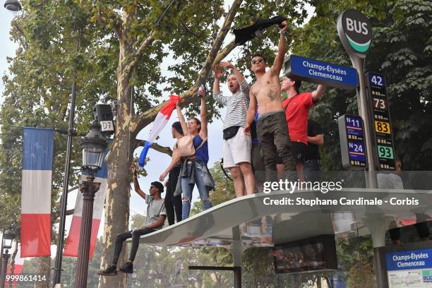 Fans celebrate the Victory of France in the World Cup 2018, on the Champs Elysees on July 15, 2018 in Paris, France.