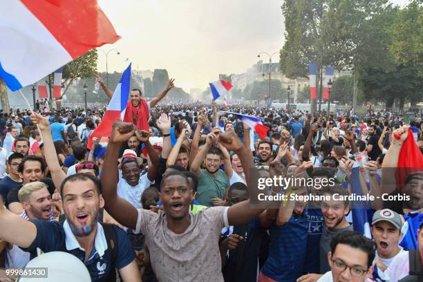 Fans celebrate the Victory of France in the World Cup 2018, on the Champs Elysees on July 15, 2018 in Paris, France.