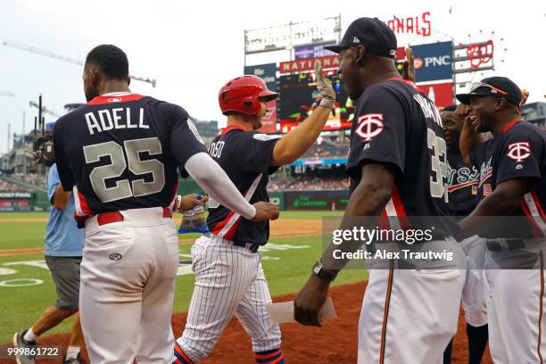 Peter Alonso of Team USA is greeted in the dugout after hitting a two-run home run in the seventh inning during the SiriusXM All-Star Futures Game at...