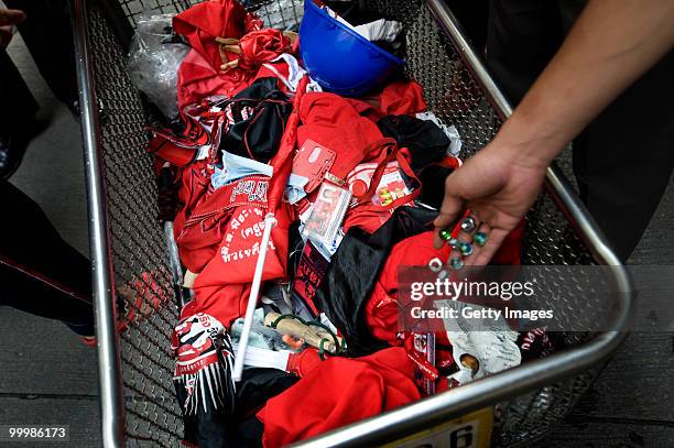 Thai anti-government red shirt protesters drop items into a bin for police as they leave the main rally site on May 19, 2010 in Bangkok, Thailand. At...