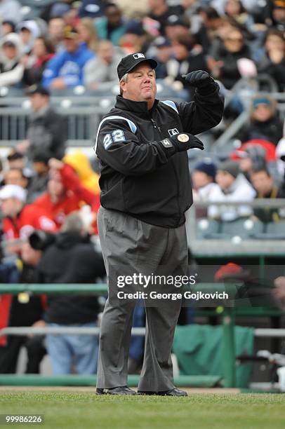 Major League Baseball umpire Joe West signals to another umpire during a game between the Cincinnati Reds and Pittsburgh Pirates at PNC Park on April...