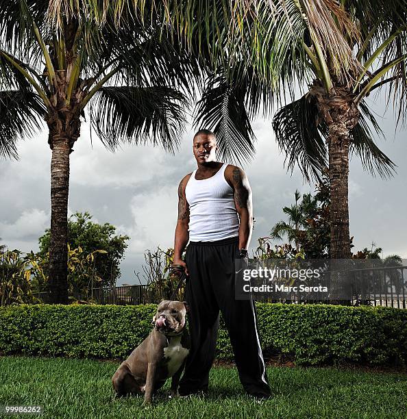 Defensive back Will Allen of the Miami Dolphins poses with his dog for a portrait on May 17, 2010 in Weston, Florida.