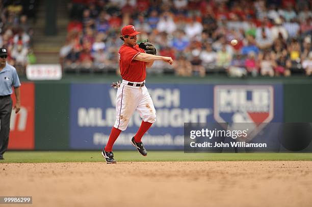 Second baseman Ian Kinsler of the Texas Rangers fields his position as he throws to first base after catching a ground ball during the game against...