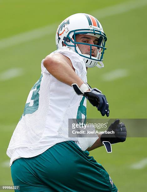 Greg Camarillo of the Miami Dolphins looks back as the ball is thrown to him during the organized team activities on May 19, 2010 at the Miami...