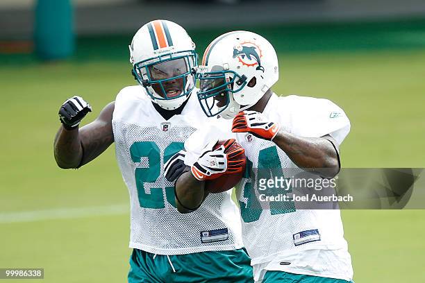 Ronnie Brown and Ricky Williams of the Miami Dolphins run together during the organized team activities on May 19, 2010 at the Miami Dolphins...