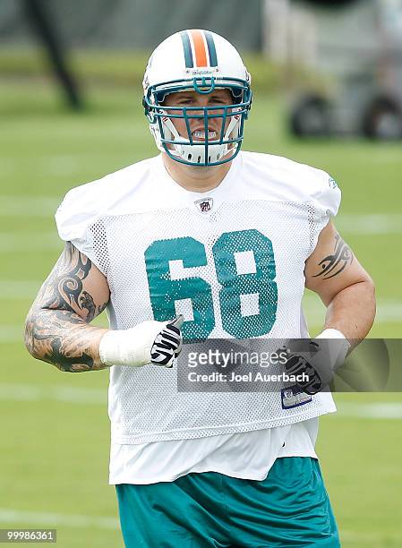 Richie Incognito of the Miami Dolphins runs drills during the organized team activities on May 19, 2010 at the Miami Dolphins training facility in...
