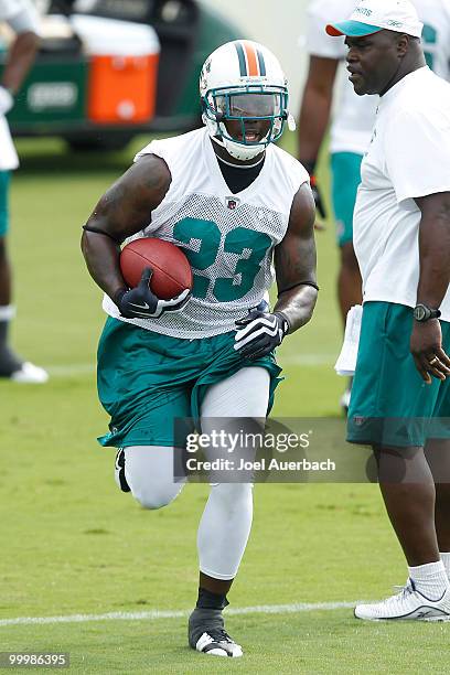 Ronnie Brown of the Miami Dolphins runs with the ball during the organized team activities on May 19, 2010 at the Miami Dolphins training facility in...