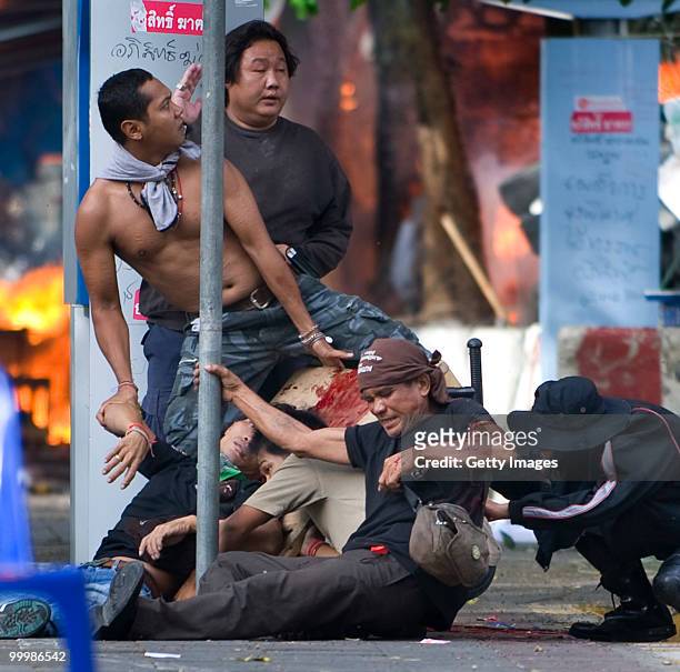 Thai anti-government red shirt protester falls after being shot by Thai military forces during fighting on May 19, 2010 in Bangkok, Thailand. At...