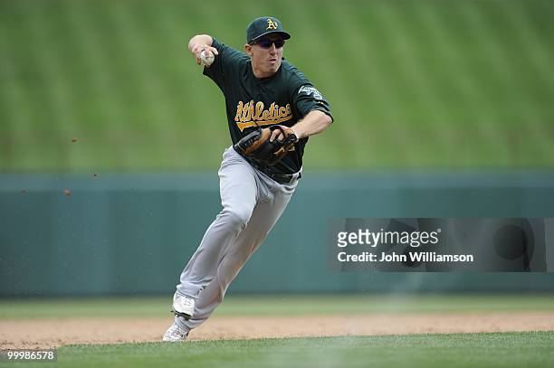 Shortstop Cliff Pennington of the Oakland Athletics fields his position as he throws home to catch the baserunner from third base trying to score...