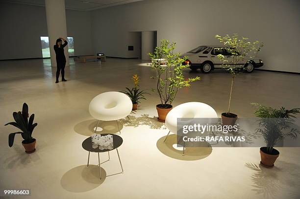 Woman stands next to the "Moriyama House" work by Pritzker winner Ryue Nishizawa during the presentation of "Ama Lurra" exhibition at the new...