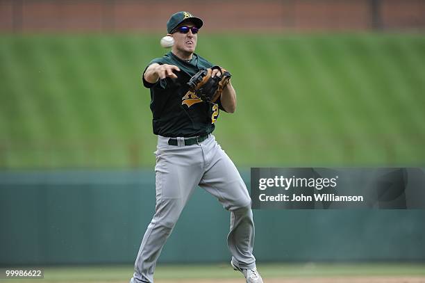 Shortstop Cliff Pennington of the Oakland Athletics fields his position as he throws home to catch the baserunner from third base trying to score...