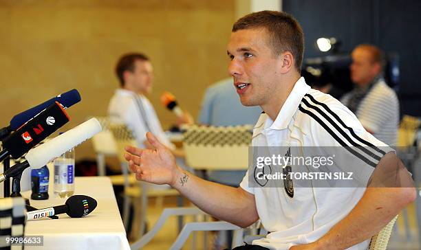 Germany's striker Lukas Podolski gives an interview during a so-called media day at the Verdura Golf and Spa resort, near Sciacca May 19, 2010. The...