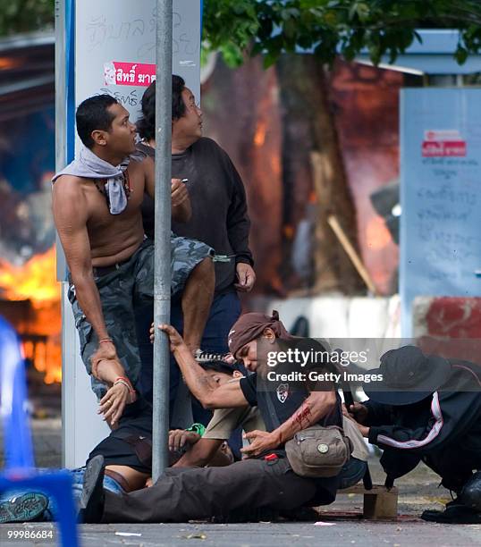 Thai anti-government red shirt protester falls after being shot by Thai military forces during fighting on May 19, 2010 in Bangkok, Thailand. At...