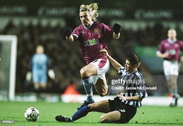 David Ginola of Aston Villa looses the ball to Leigh Bromby of Sheffield Wednesday during the Worthington Cup fourth round match between Aston Villa...