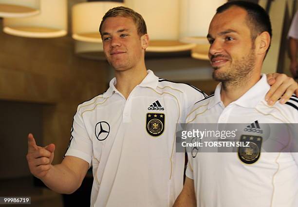 Germany's goalkeeper Manuel Neuer and defender Heiko Westermann come down a stairs with their teammates during a so-called media day at the Verdura...