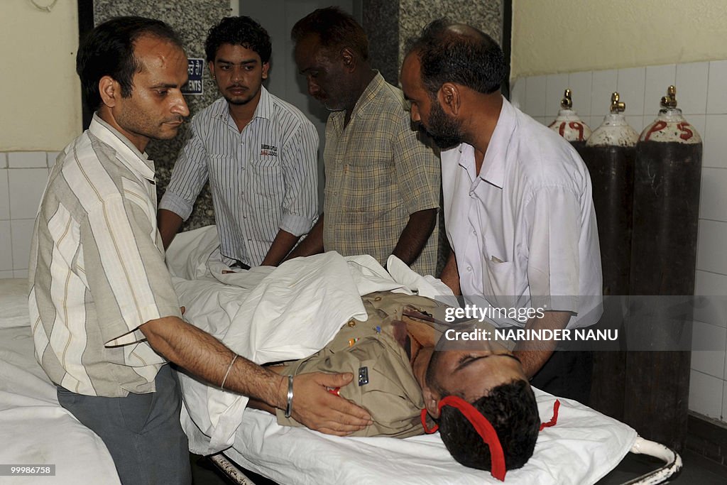 Indian hospital staff use a trolley to m