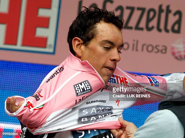 Australian Richie Porte puts on the pink jersey of leader of the 93rd Giro d'Italia on the podium of the11 st stage going from Lucera to L'Aquila on...