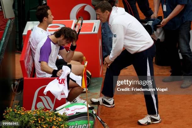 Philip Kohlschreiber , Christopher Kas and national coach Patrick Kuehnen of Germany look on during the double match against Juan Monaco and Horacio...