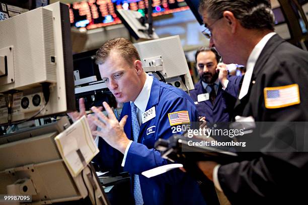 Edward Zelles, left, works at a post on the floor of the New York Stock Exchange in New York, U.S., on Wednesday, May 19, 2010. U.S. Stocks...