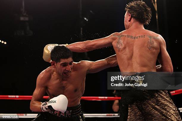 Paulie Malignaggi hits Amir Khan of Great Britain during the WBA light welterweight title fight at Madison Square Garden on May 15, 2010 in New York...