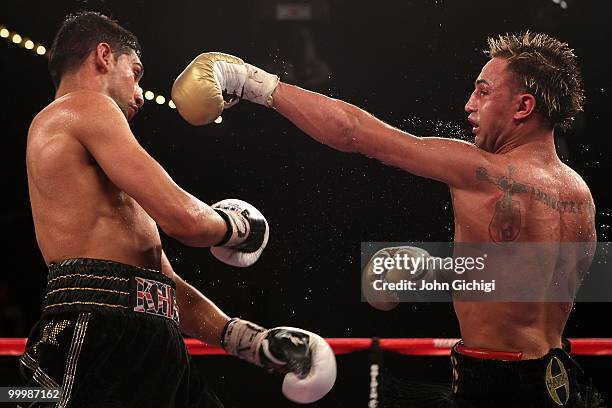 Paulie Malignaggi hits Amir Khan of Great Britain during the WBA light welterweight title fight at Madison Square Garden on May 15, 2010 in New York...